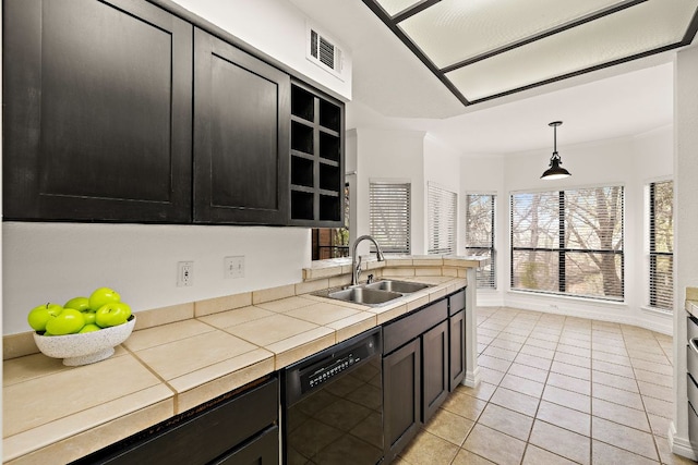 kitchen with dark cabinetry, visible vents, light tile patterned flooring, a sink, and black dishwasher