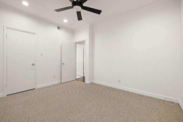 unfurnished bedroom featuring visible vents, ornamental molding, recessed lighting, carpet floors, and baseboards