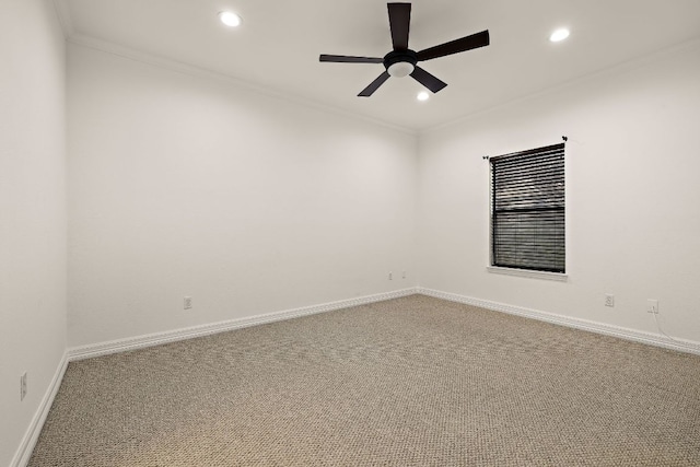 empty room with baseboards, carpet floors, ceiling fan, and crown molding