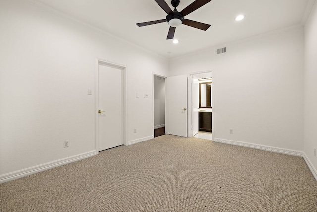 unfurnished bedroom featuring visible vents, baseboards, carpet floors, and ornamental molding