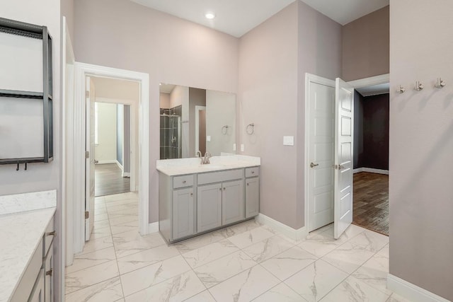 838 Kenney Fort Xing, Round Rock, TX 78665 - full bathroom featuring vanity, baseboards, marble look tiles, and a shower
