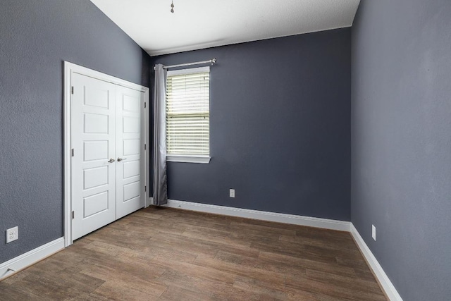 838 Kenney Fort Xing, Round Rock, TX 78665 - unfurnished bedroom with wood finished floors and baseboards