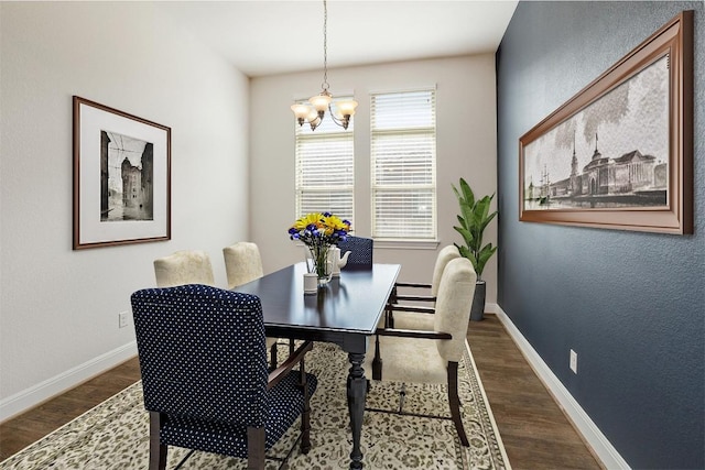 dining room with baseboards, an inviting chandelier, and dark wood-style flooring