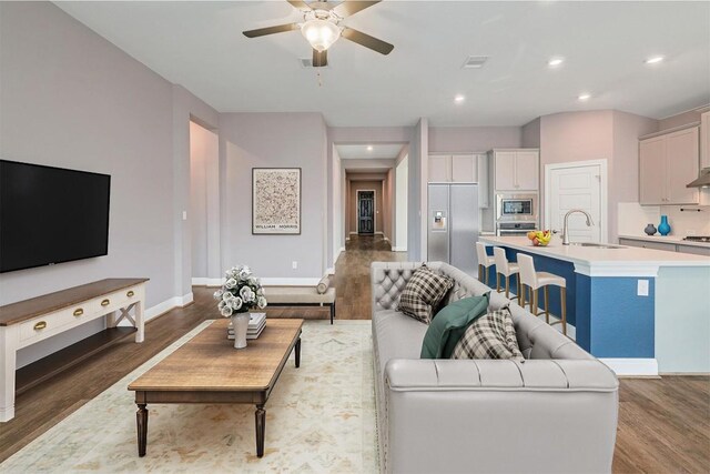 838 Kenney Fort Xing, Round Rock, TX 78665 - living area featuring wood finished floors, a ceiling fan, recessed lighting, and baseboards