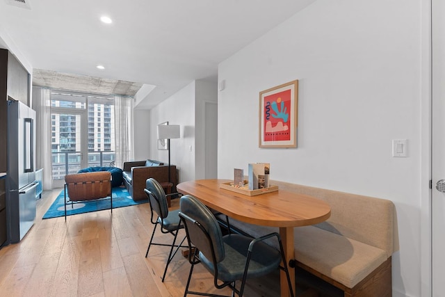 dining area with recessed lighting, visible vents, and light wood-style flooring