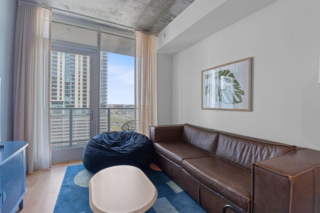 living room with light wood finished floors and floor to ceiling windows