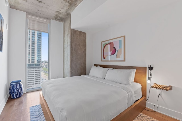 bedroom featuring baseboards and wood finished floors