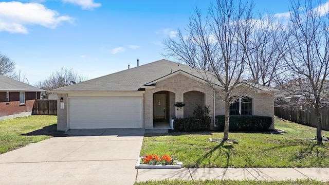 view of front of home with fence, concrete driveway, an attached garage, a front yard, and brick siding