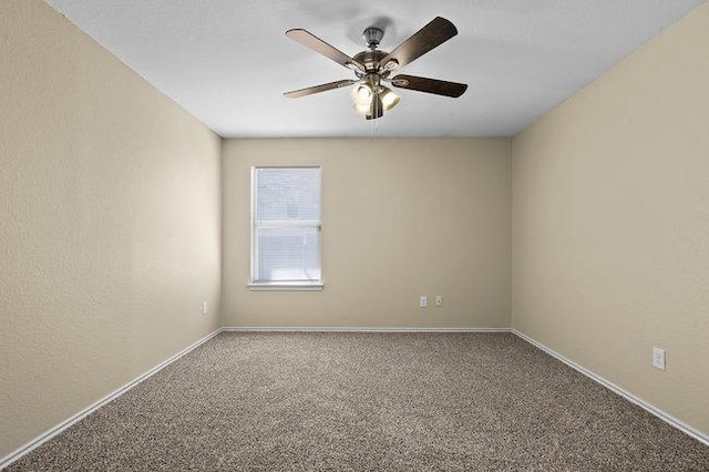 carpeted empty room featuring baseboards and ceiling fan