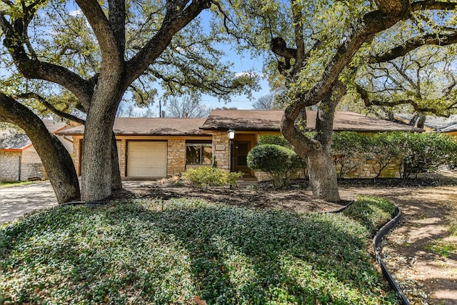 view of front of property featuring stone siding and an attached garage