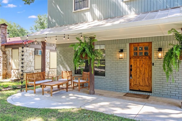 1019 Allen Ave, New Braunfels, TX 78130 - view of exterior entry featuring brick siding, metal roof, and covered porch