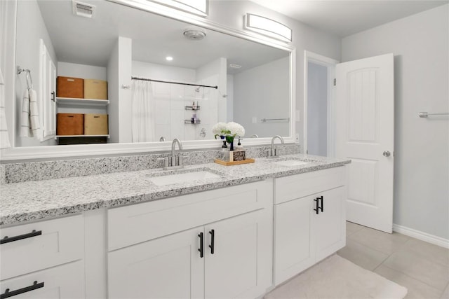 1019 Allen Ave, New Braunfels, TX 78130 - bathroom with double vanity, tile patterned flooring, baseboards, and curtained shower