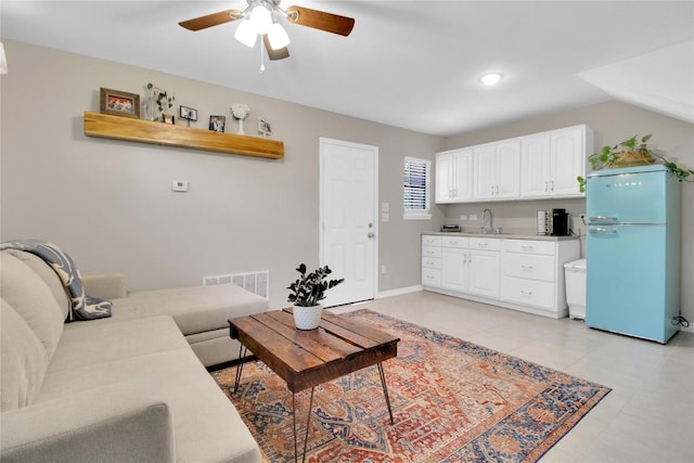 1019 Allen Ave, New Braunfels, TX 78130 - living area featuring ceiling fan, light tile patterned floors, and baseboards