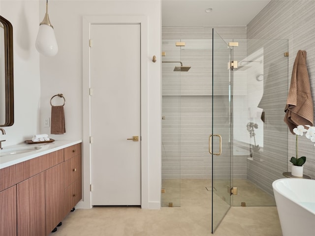 bathroom featuring a freestanding bath, a stall shower, and vanity