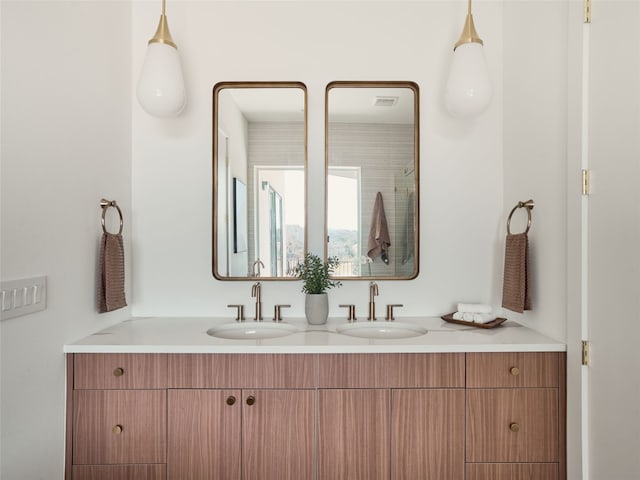 full bath with double vanity and a sink