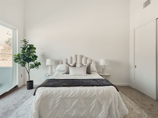 bedroom with carpet, visible vents, and baseboards