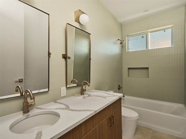 full bath with double vanity, toilet, shower / bathtub combination, and a sink