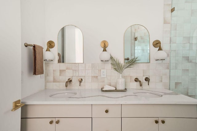 full bath with double vanity, tasteful backsplash, and a sink