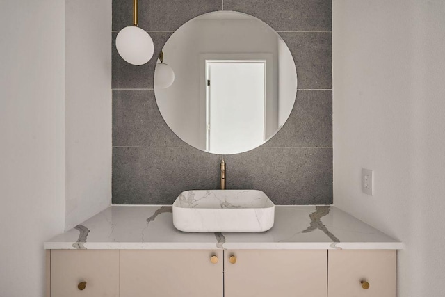 bathroom with vanity and tile walls