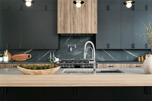 kitchen with decorative backsplash, wood counters, and a sink