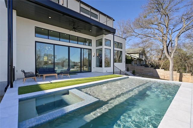 view of swimming pool featuring a ceiling fan, a pool with connected hot tub, an outdoor living space, a patio, and fence