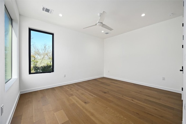 unfurnished room with visible vents, recessed lighting, baseboards, and wood finished floors