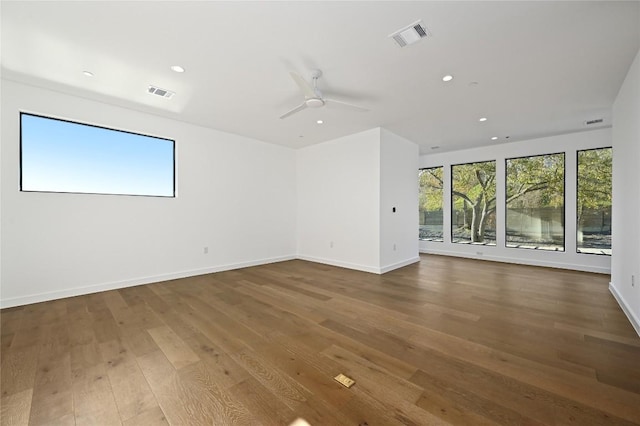 spare room featuring visible vents, recessed lighting, baseboards, and hardwood / wood-style flooring