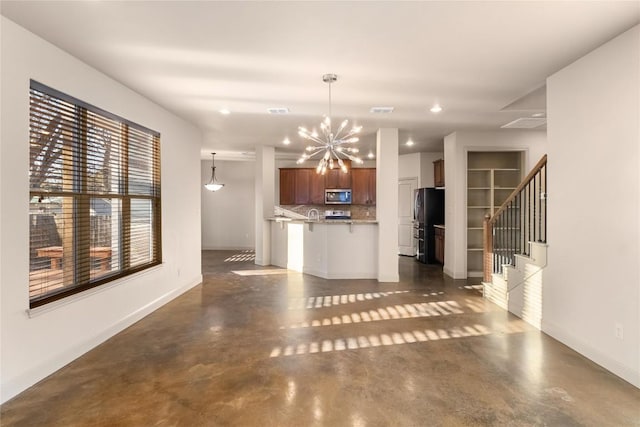 5603 Clay Ave Unit B, Austin, TX 78756 - unfurnished living room with a chandelier, finished concrete floors, stairs, and recessed lighting