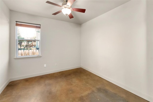 spare room featuring baseboards and a ceiling fan