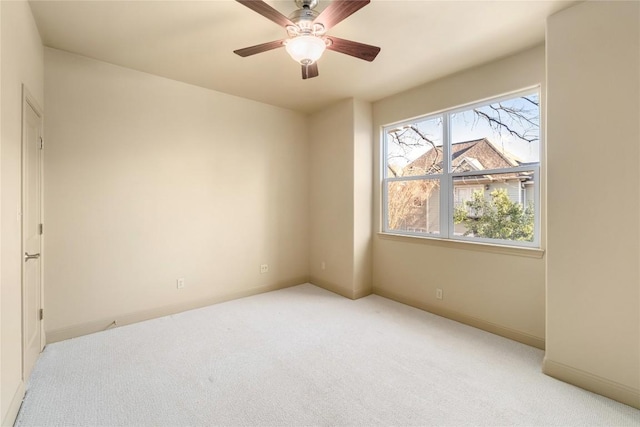 spare room with light carpet and ceiling fan