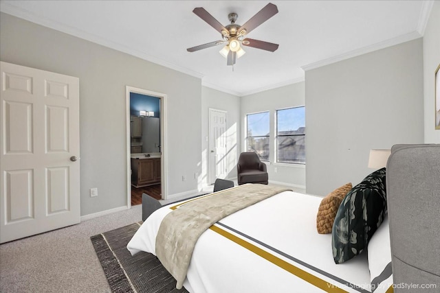 carpeted bedroom featuring ensuite bath, crown molding, baseboards, and ceiling fan