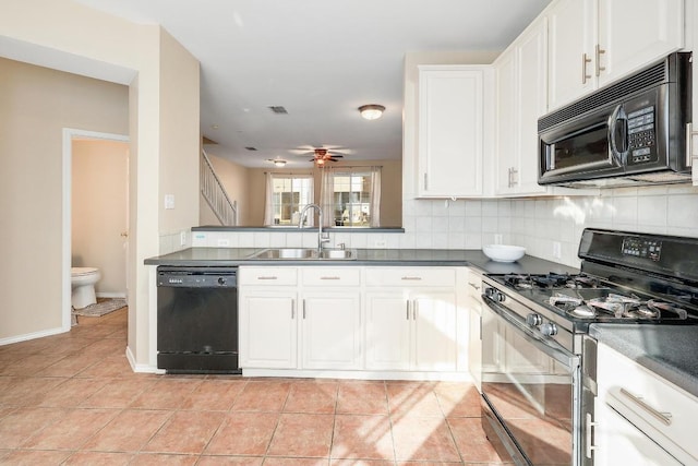 kitchen featuring a sink, tasteful backsplash, black appliances, and white cabinetry