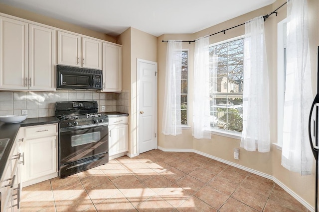 kitchen with light tile patterned floors, decorative backsplash, plenty of natural light, and black appliances