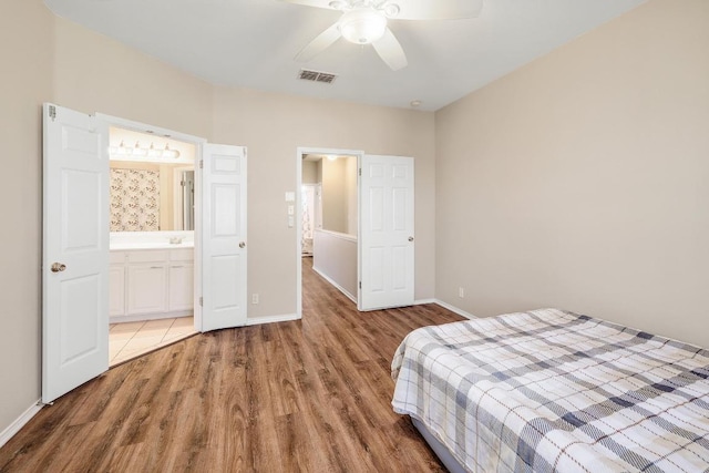 bedroom with visible vents, ceiling fan, baseboards, and light wood-style floors