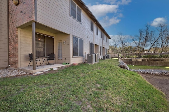 exterior space with a patio area, central air condition unit, and fence