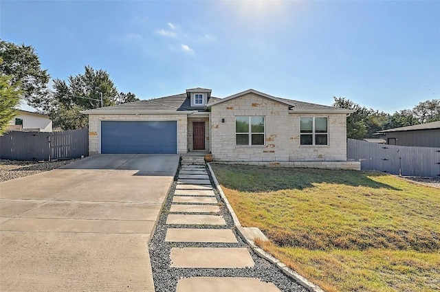 view of front of property featuring concrete driveway, fence, a garage, and a front yard