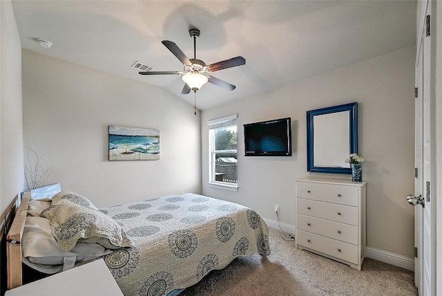 carpeted bedroom featuring visible vents, a ceiling fan, baseboards, and vaulted ceiling