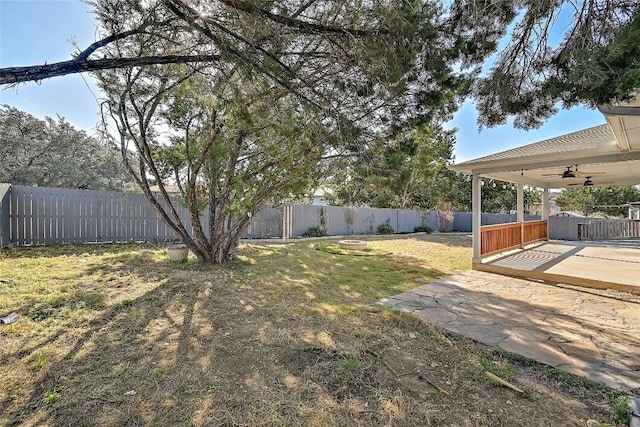 view of yard featuring a ceiling fan, a patio, and a fenced backyard