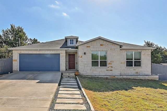 view of front of house with a front yard, fence, an attached garage, a shingled roof, and concrete driveway