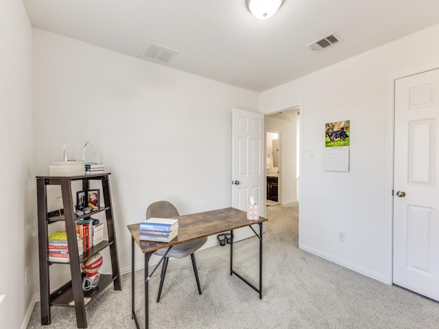 office space featuring visible vents, light carpet, and baseboards