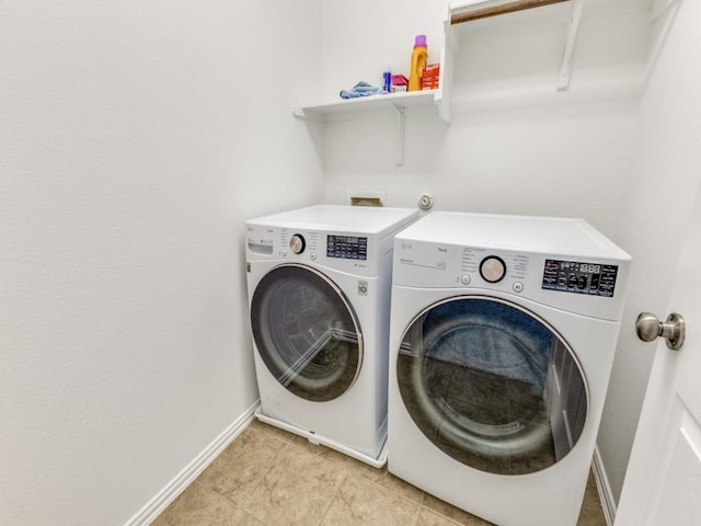 laundry room with washing machine and clothes dryer, laundry area, baseboards, and light tile patterned floors