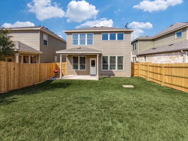 back of property featuring a yard, a patio, and a fenced backyard