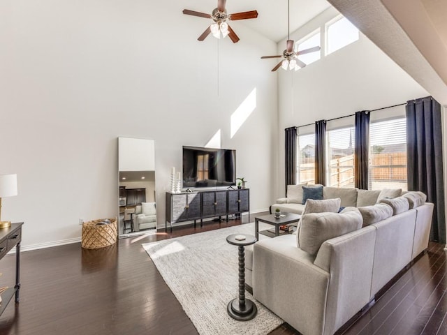 living area featuring ceiling fan, dark wood-type flooring, and baseboards