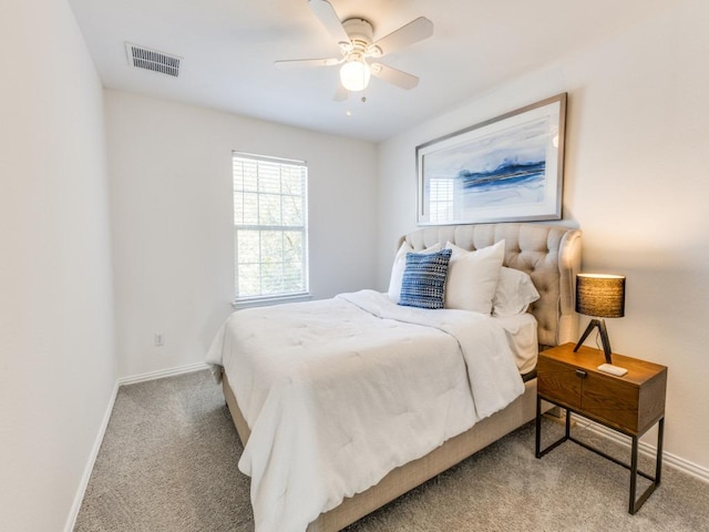 bedroom featuring visible vents, a ceiling fan, baseboards, and carpet floors