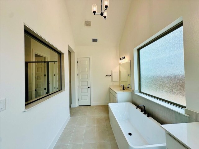 1670 Headwaters Blvd, Dripping Springs, TX 78620 - bathroom featuring a soaking tub, vanity, high vaulted ceiling, a chandelier, and a shower stall