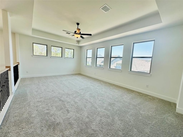 1670 Headwaters Blvd, Dripping Springs, TX 78620 - unfurnished living room with a tray ceiling, a ceiling fan, and carpet floors
