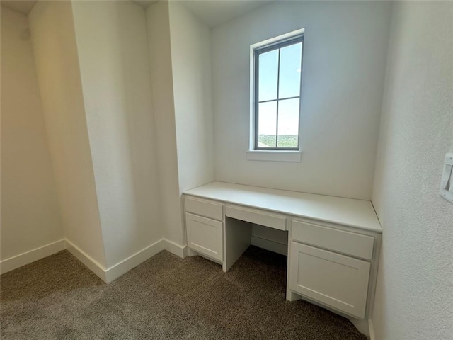 1670 Headwaters Blvd, Dripping Springs, TX 78620 - unfurnished office featuring dark carpet, built in desk, and baseboards