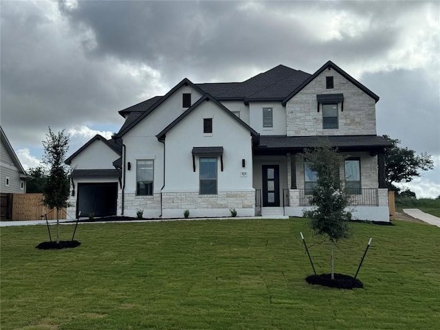 1670 Headwaters Blvd, Dripping Springs, TX 78620 - view of front facade featuring stone siding, stucco siding, covered porch, and an attached garage