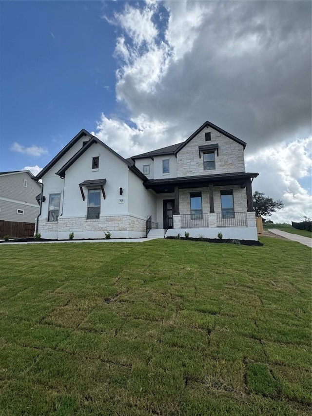 1670 Headwaters Blvd, Dripping Springs, TX 78620 - view of front facade featuring stone siding, covered porch, a front lawn, and stucco siding