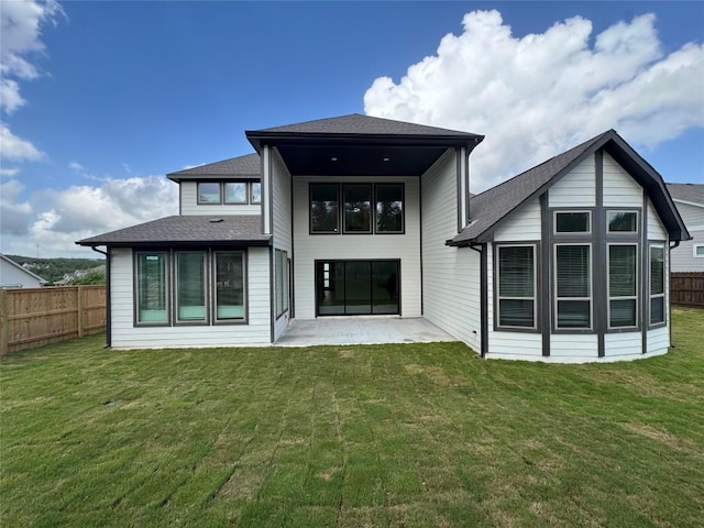 1670 Headwaters Blvd, Dripping Springs, TX 78620 - back of property featuring a fenced backyard, a patio area, and a shingled roof